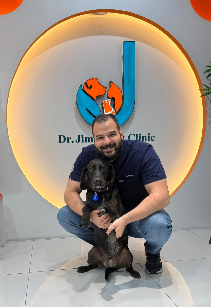 Dr. Jimmy with a rescue dog in the reception of Dr. Jimmy Pet Clinic, Ras Al Khaimah